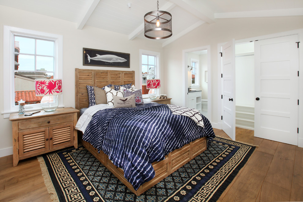 Photo of a traditional bedroom in Orange County with beige walls and medium hardwood floors.