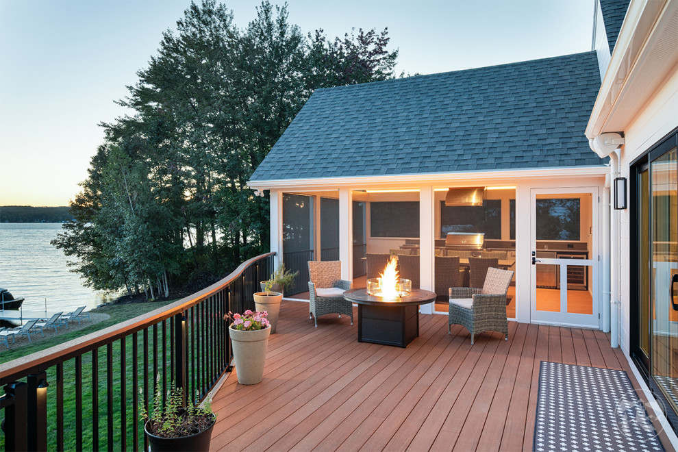 Photo of a large country backyard and first floor deck in Other with an outdoor kitchen and mixed railing.