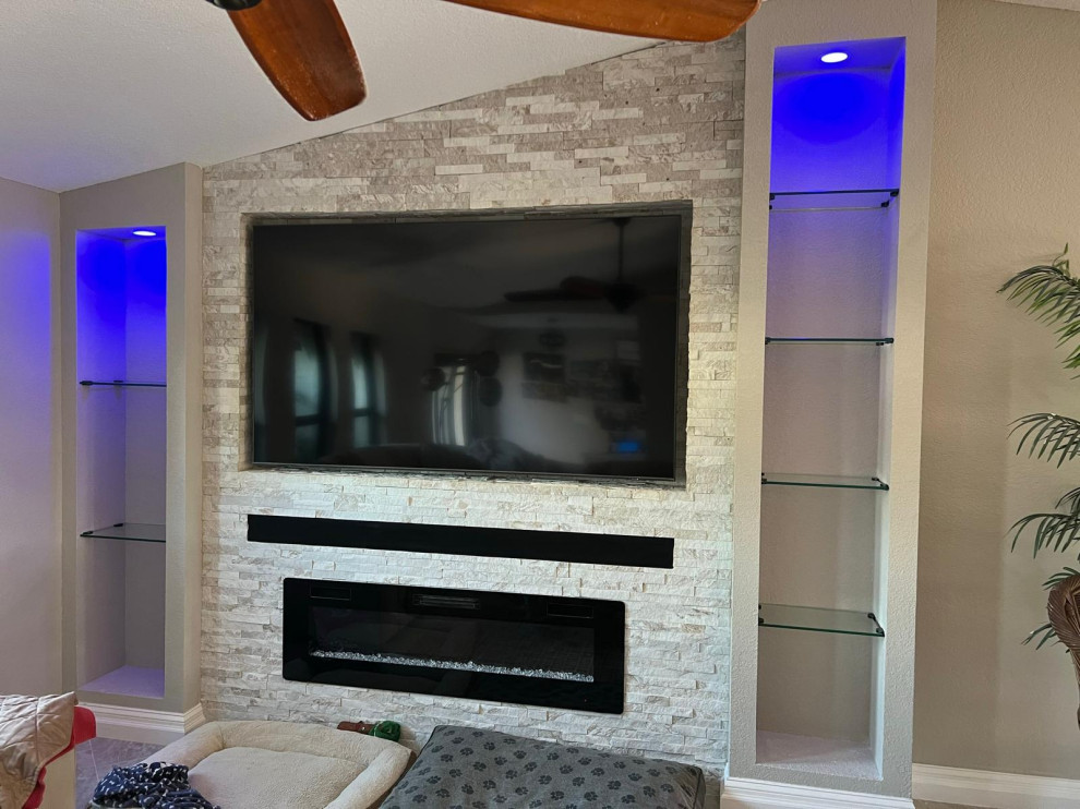 Inspiration for a modern games room in Miami with a stone fireplace surround.