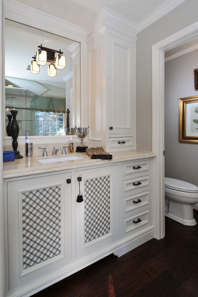 Traditional bathroom in Atlanta with an undermount sink, recessed-panel cabinets and white cabinets.