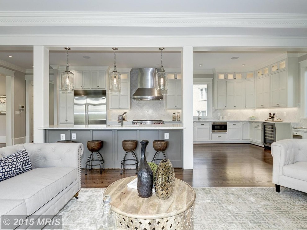 Eat-in kitchen - mid-sized transitional l-shaped medium tone wood floor eat-in kitchen idea in DC Metro with an undermount sink, shaker cabinets, white cabinets, quartz countertops, gray backsplash, stainless steel appliances, subway tile backsplash and an island