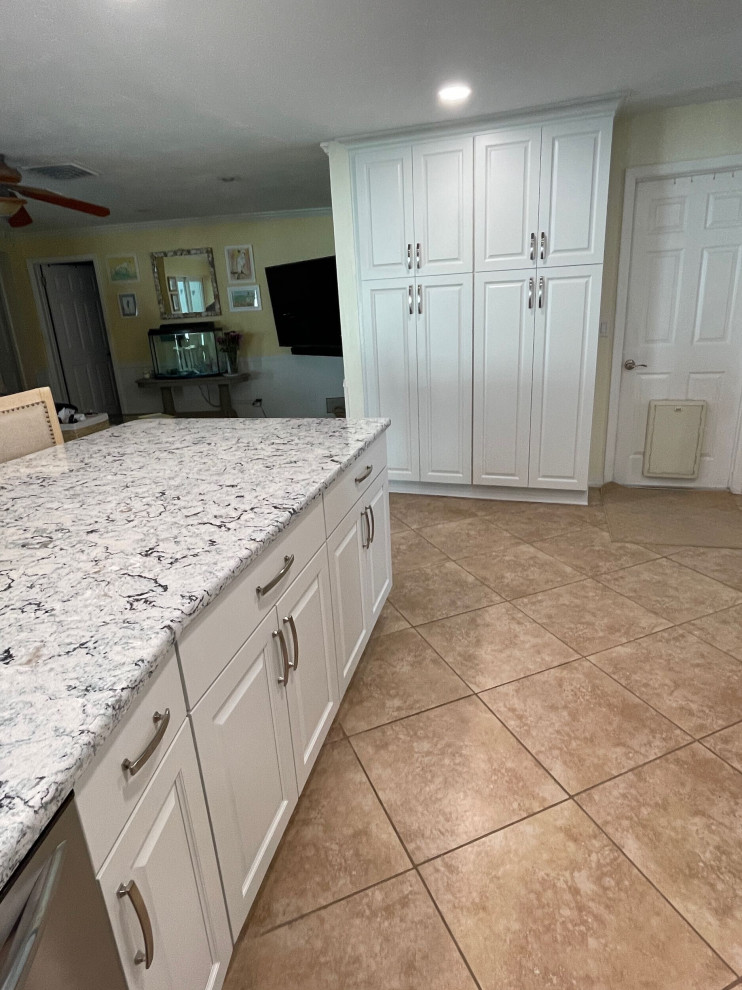 This is an example of a medium sized classic kitchen/diner in Tampa with shaker cabinets, white cabinets, engineered stone countertops, blue splashback and ceramic splashback.
