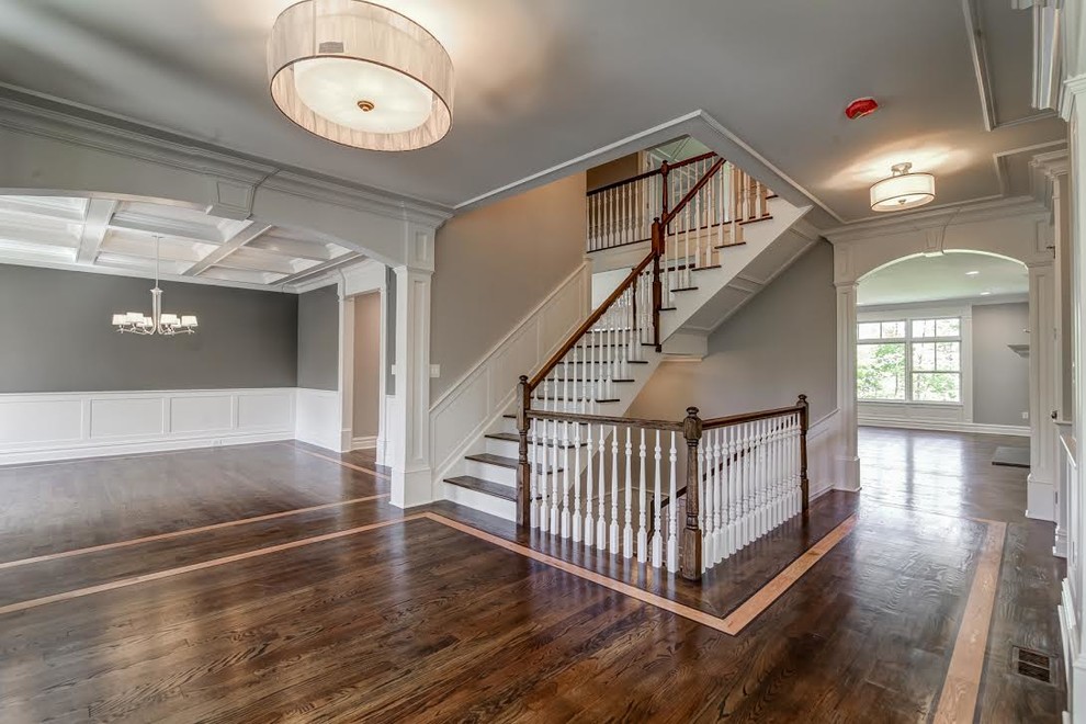 Transitional wood l-shaped staircase in New York with wood risers and wood railing.