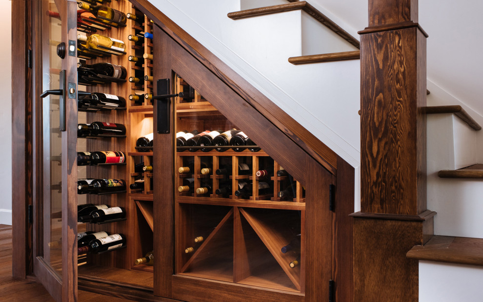 Photo of a small traditional wine cellar in Portland with dark hardwood floors, storage racks and brown floor.