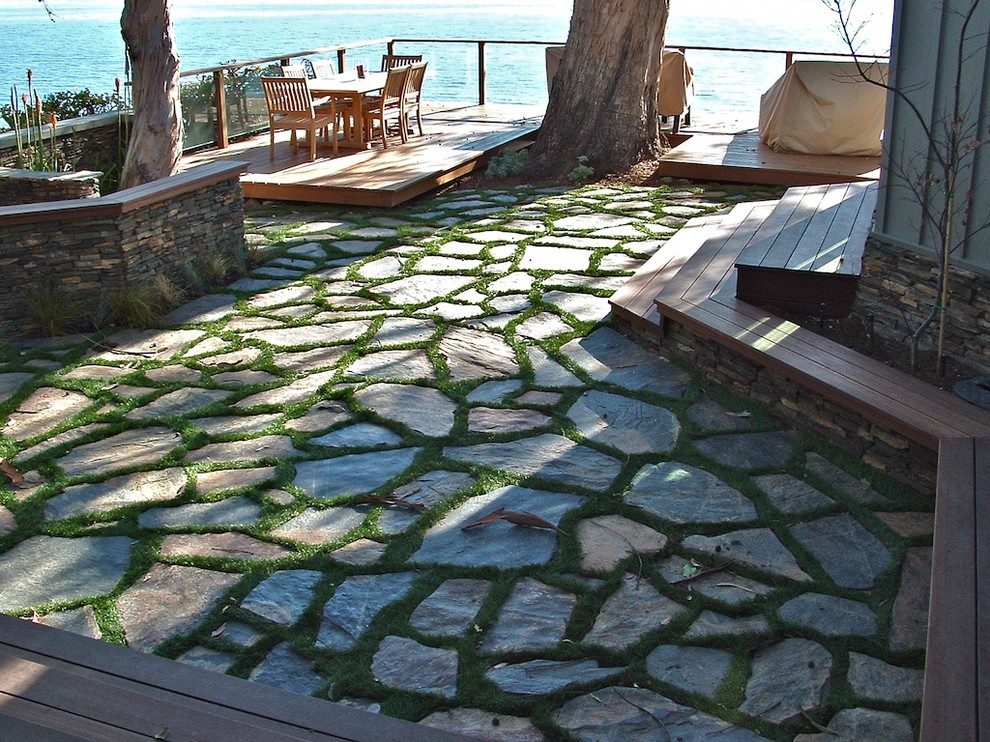 This is an example of a small traditional backyard garden in Other with natural stone pavers.