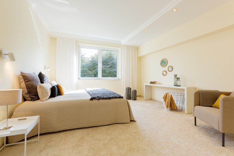 Photo of a transitional master bedroom in Dusseldorf with beige walls, carpet and beige floor.