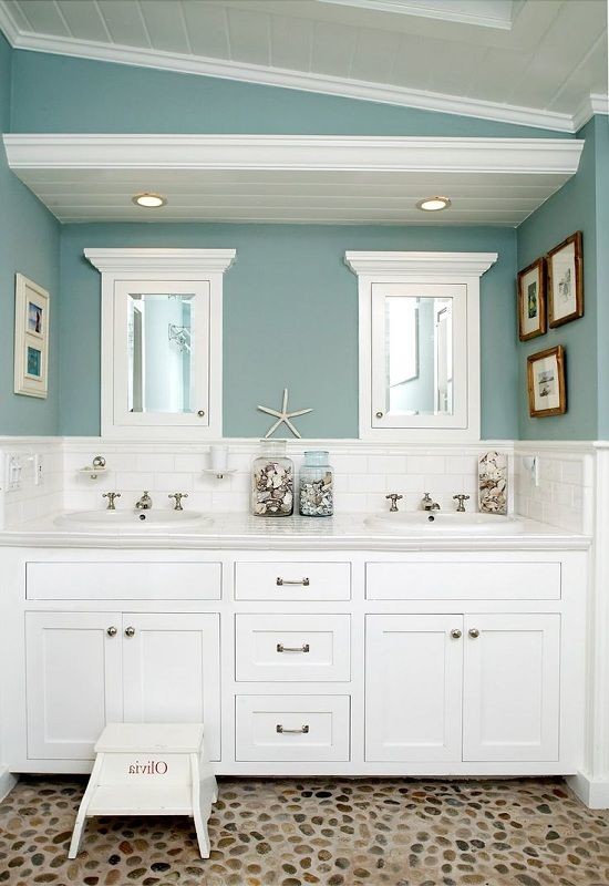 Photo of a mid-sized beach style master bathroom in Other with shaker cabinets, white cabinets, white tile, subway tile, blue walls, pebble tile floors, a drop-in sink, engineered quartz benchtops and multi-coloured floor.