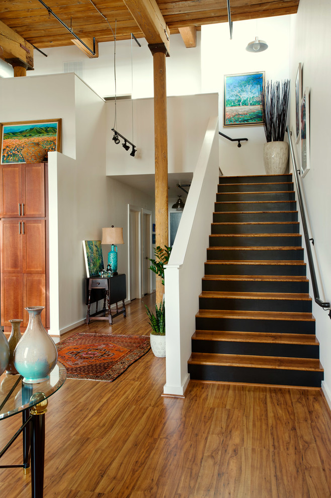 Photo of a mid-sized industrial wood l-shaped staircase in Other with painted wood risers.