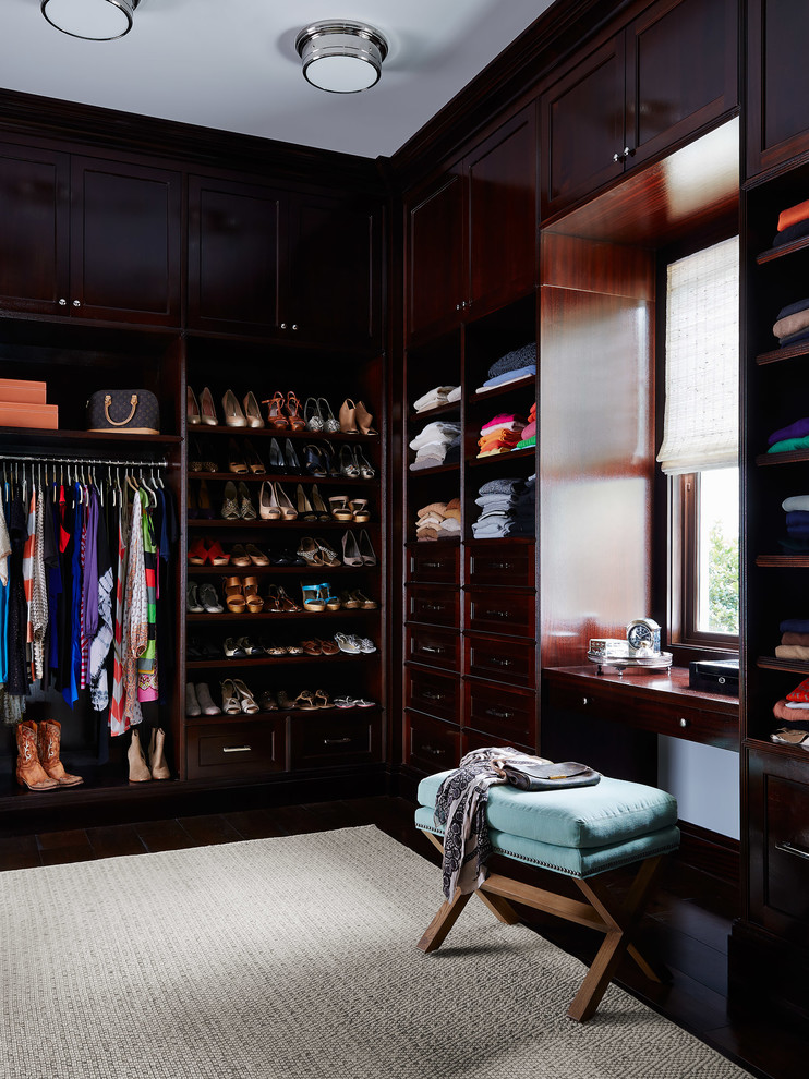 Design ideas for a beach style storage and wardrobe in Jacksonville with dark wood cabinets.