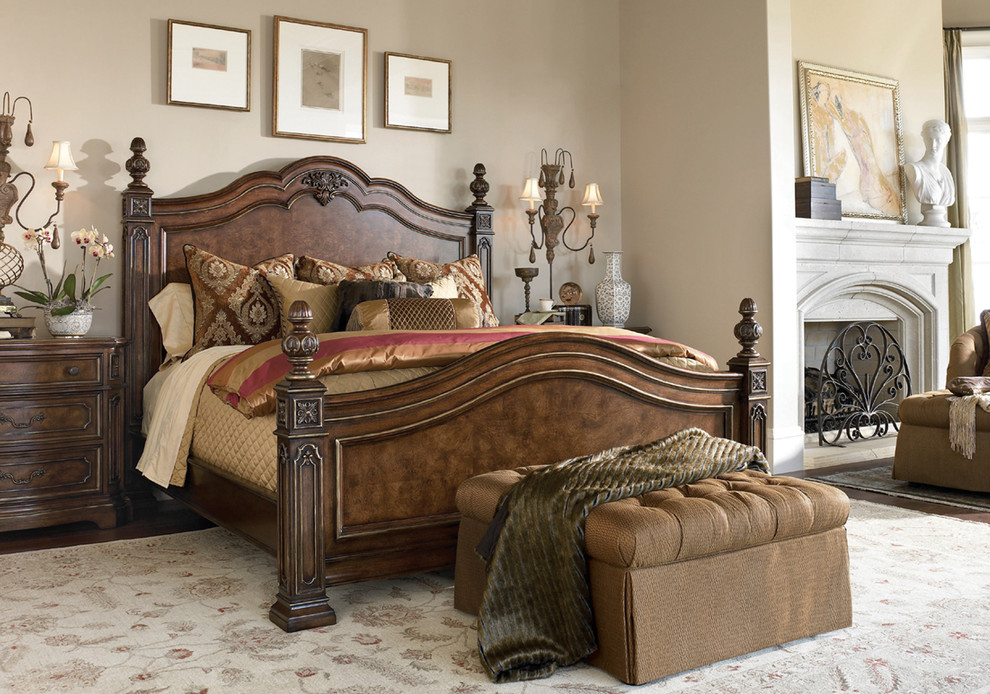 Design ideas for a large traditional master bedroom in Other with beige walls, dark hardwood floors, a standard fireplace and a plaster fireplace surround.
