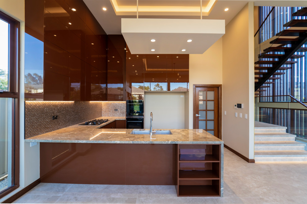 Photo of a large contemporary u-shaped open plan kitchen in Sydney with an undermount sink, flat-panel cabinets, brown cabinets, marble benchtops, brown splashback, glass tile splashback, black appliances, ceramic floors, with island, beige floor, brown benchtop and vaulted.
