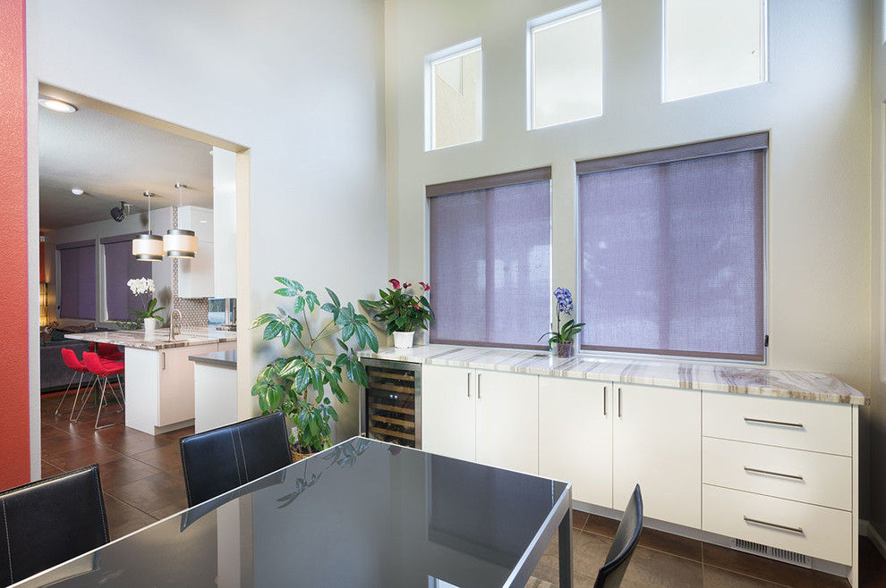 Dining room - contemporary brown floor dining room idea with white walls