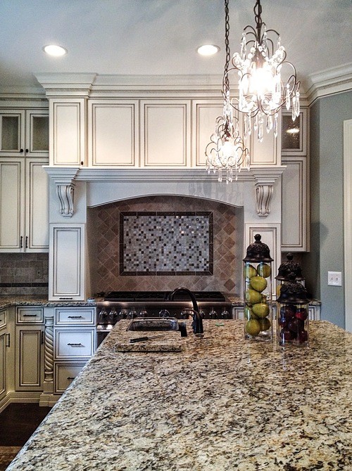 Transitional single-wall medium tone wood floor open concept kitchen photo in Columbus with a drop-in sink, beaded inset cabinets, white cabinets, granite countertops, stainless steel appliances and an island
