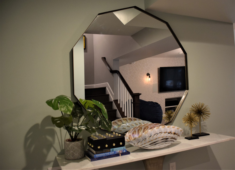 Example of a mid-sized transitional look-out carpeted and gray floor basement design in Baltimore with green walls and no fireplace