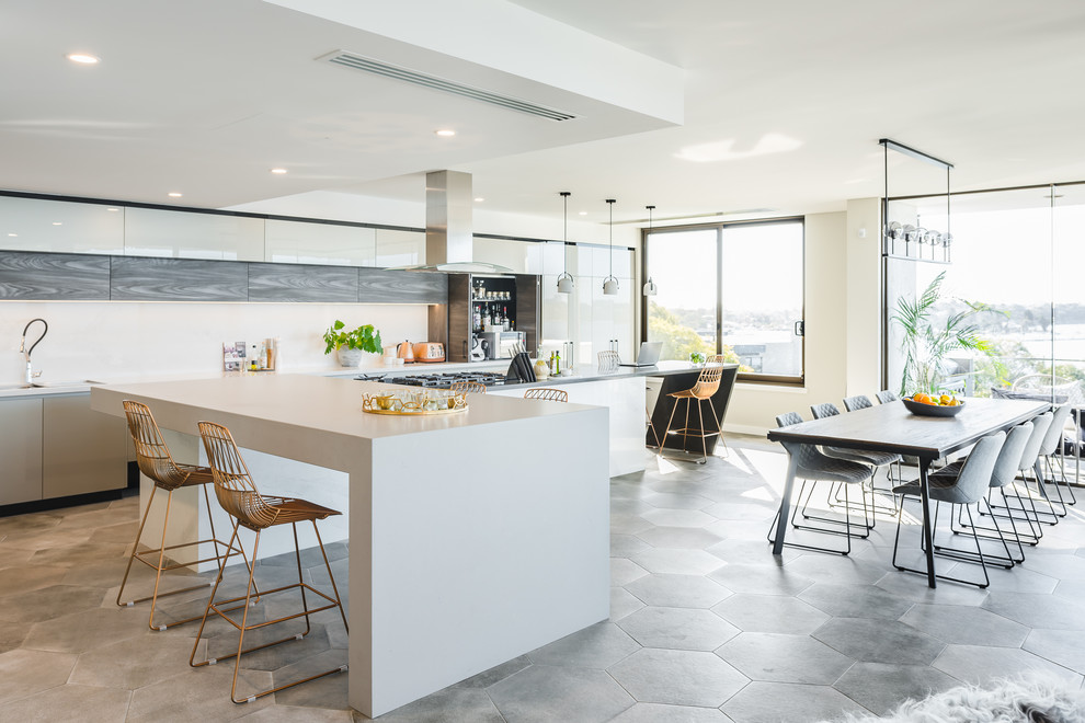 Contemporary l-shaped eat-in kitchen in Perth with flat-panel cabinets, white cabinets, with island and grey floor.