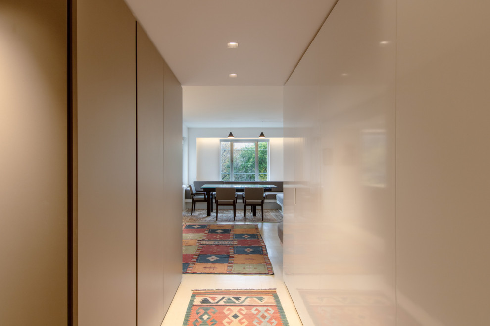 Idee per un piccolo ingresso o corridoio minimalista con pareti beige, parquet chiaro, pavimento grigio e pannellatura