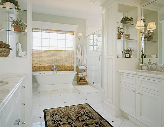 Photo of a traditional bathroom in Phoenix with an undermount sink, recessed-panel cabinets, white cabinets, marble benchtops, a freestanding tub, an alcove shower, white tile and stone tile.