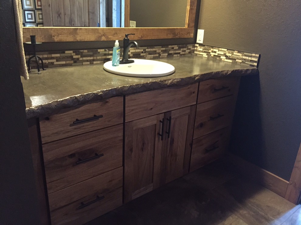 Mid-sized mountain style master beige tile and mosaic tile porcelain tile home design photo with shaker cabinets, medium tone wood cabinets, brown walls, a drop-in sink and concrete countertops