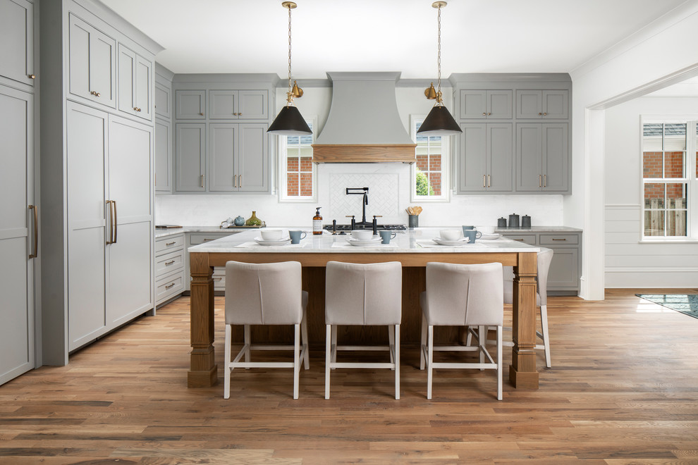 Large transitional l-shaped medium tone wood floor open concept kitchen photo in Charlotte with beaded inset cabinets, gray cabinets, marble countertops, stainless steel appliances and an island