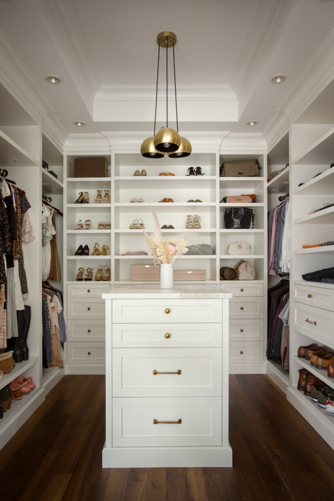 Large transitional women's walk-in wardrobe in Other with shaker cabinets, white cabinets, medium hardwood floors, brown floor and recessed.