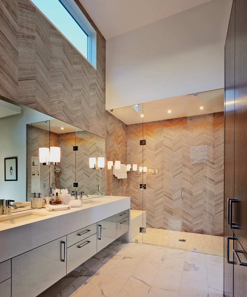 Design ideas for a contemporary bathroom in Denver with an undermount sink, flat-panel cabinets, dark wood cabinets, limestone benchtops, brown tile, stone tile, beige walls, marble floors and with a sauna.