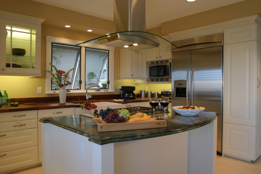 Design ideas for a contemporary eat-in kitchen in Hawaii with raised-panel cabinets, wood benchtops, stainless steel appliances, a farmhouse sink, white cabinets and green benchtop.
