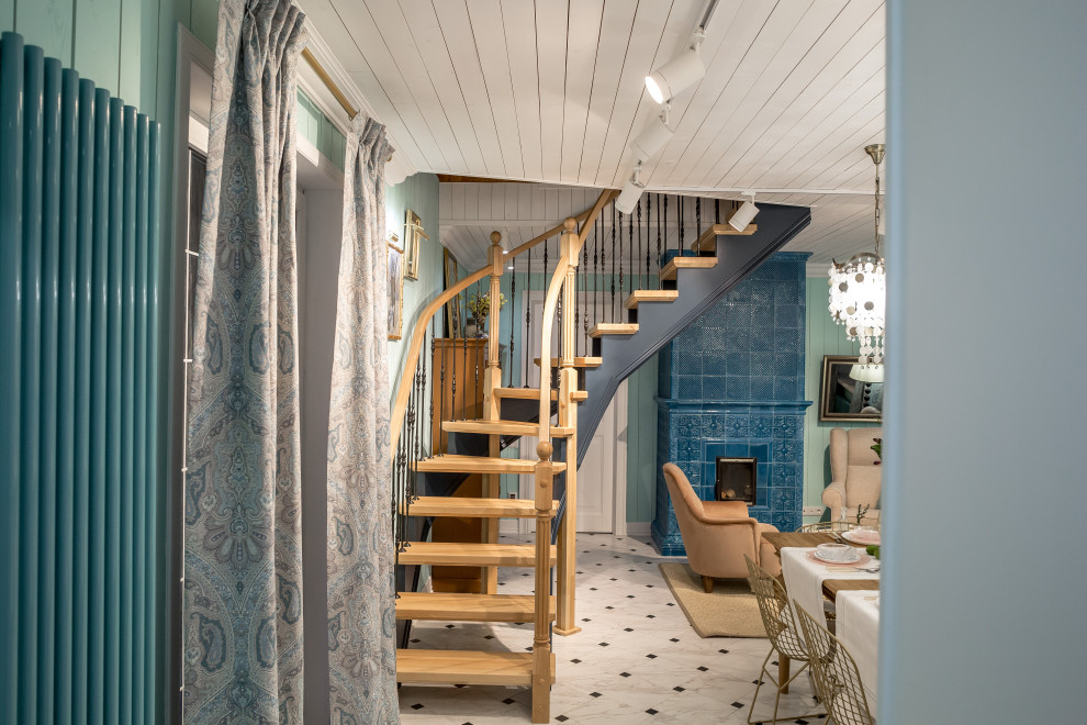 This is an example of a small mediterranean wood curved staircase in Moscow with planked wall panelling.