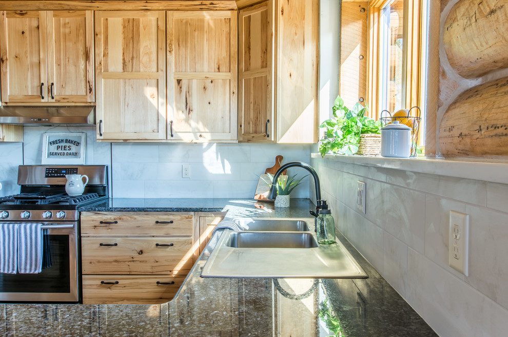 Enclosed kitchen - large rustic u-shaped enclosed kitchen idea in Denver with a double-bowl sink, shaker cabinets, light wood cabinets, granite countertops, gray backsplash, porcelain backsplash, stainless steel appliances and brown countertops