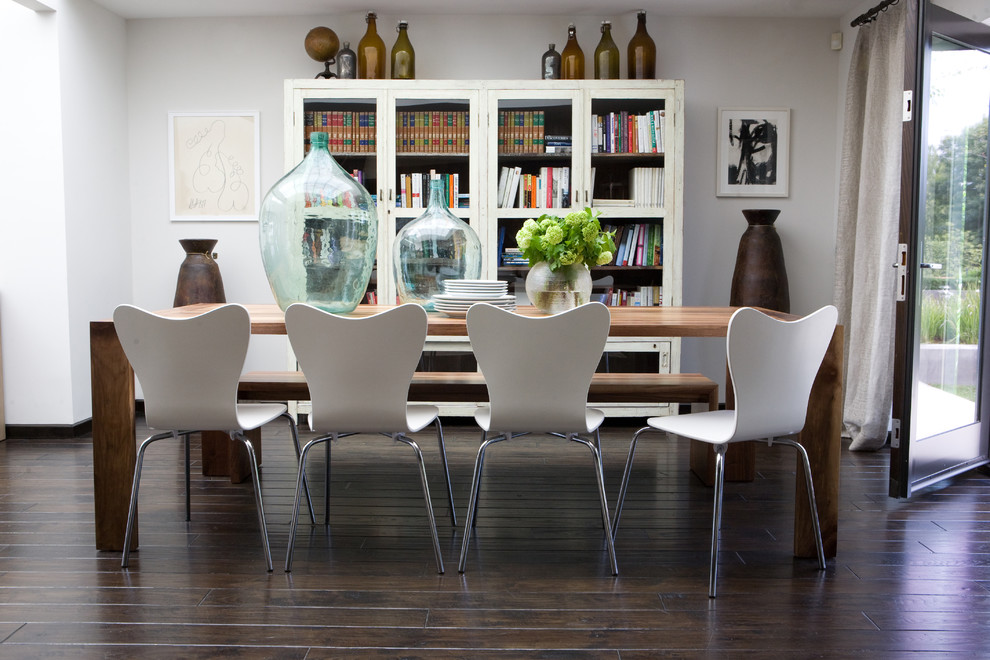 Design ideas for a mid-sized eclectic open plan dining in Los Angeles with white walls and dark hardwood floors.