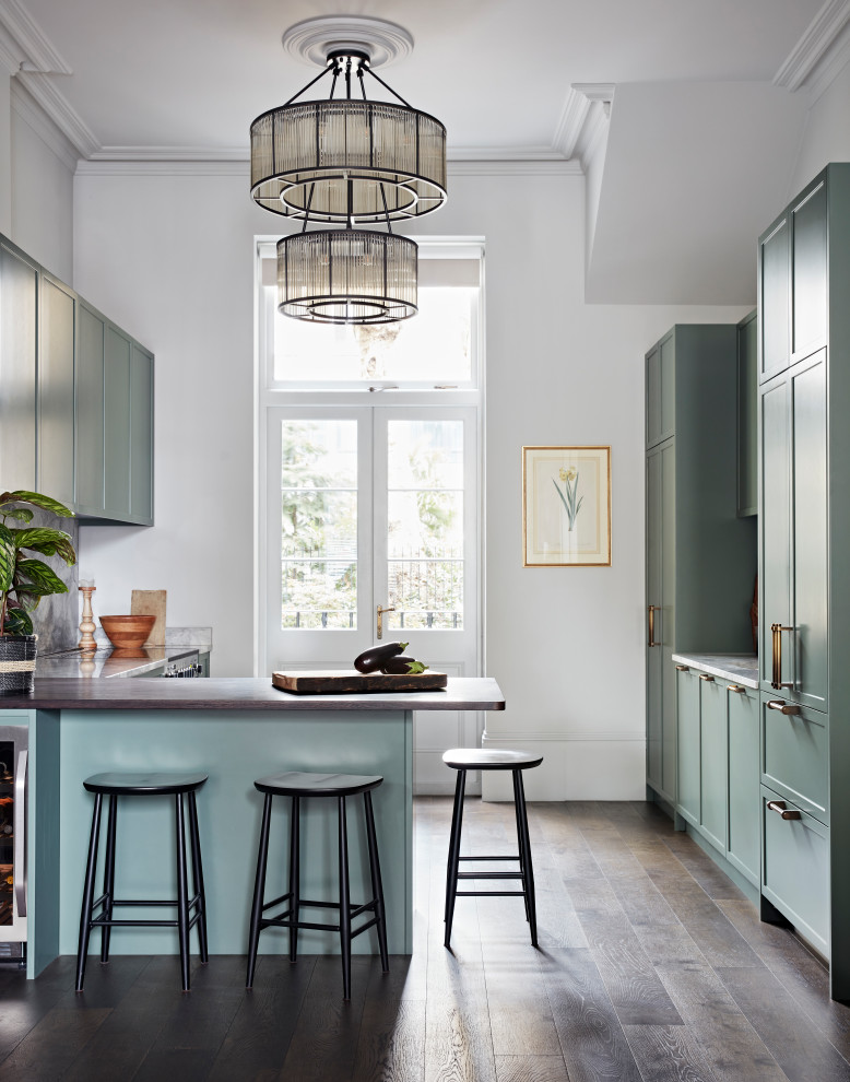 Inspiration for a mid-sized transitional u-shaped open plan kitchen in London with an integrated sink, shaker cabinets, quartzite benchtops, grey splashback, marble splashback, stainless steel appliances, dark hardwood floors, no island and grey benchtop.