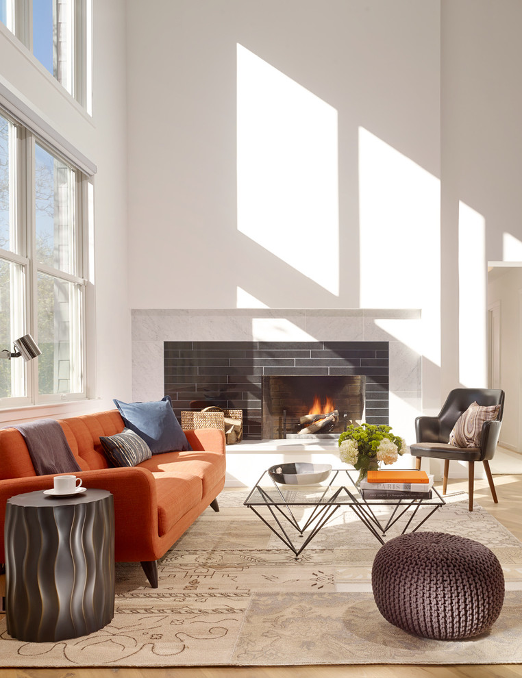 Design ideas for a mid-sized contemporary open concept living room in San Francisco with white walls, light hardwood floors, a standard fireplace and a tile fireplace surround.