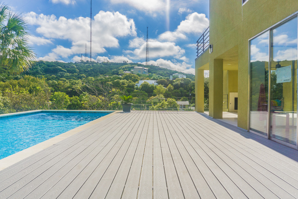 Design ideas for a large contemporary side yard rectangular lap pool in Austin with decking.