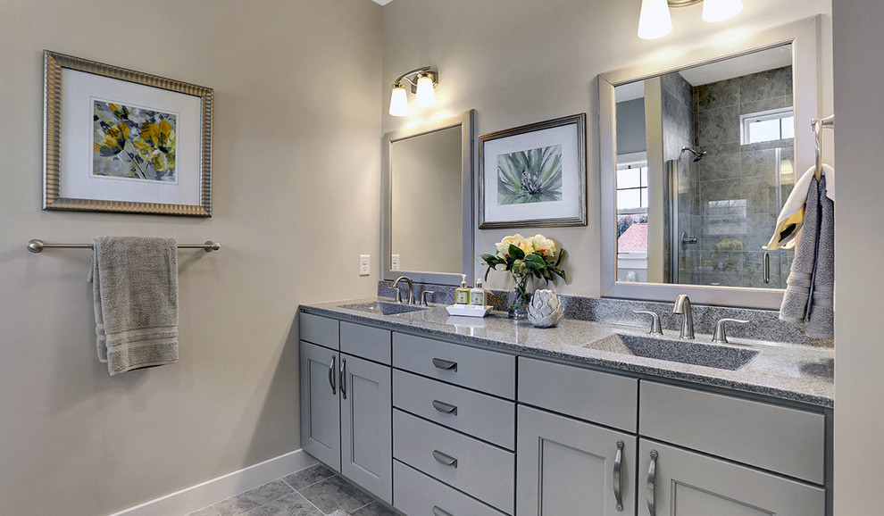 Design ideas for a mid-sized traditional master bathroom in Other with grey cabinets, an alcove shower, beige walls, ceramic floors, an integrated sink, engineered quartz benchtops, grey floor and a hinged shower door.