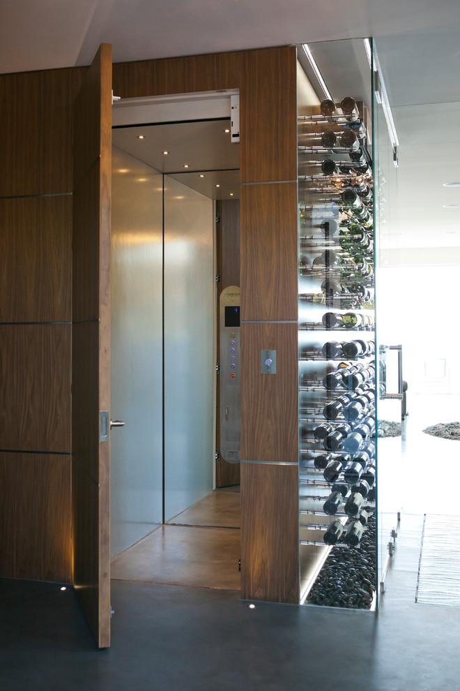 Inspiration for a contemporary wine cellar in Vancouver with concrete floors and grey floor.