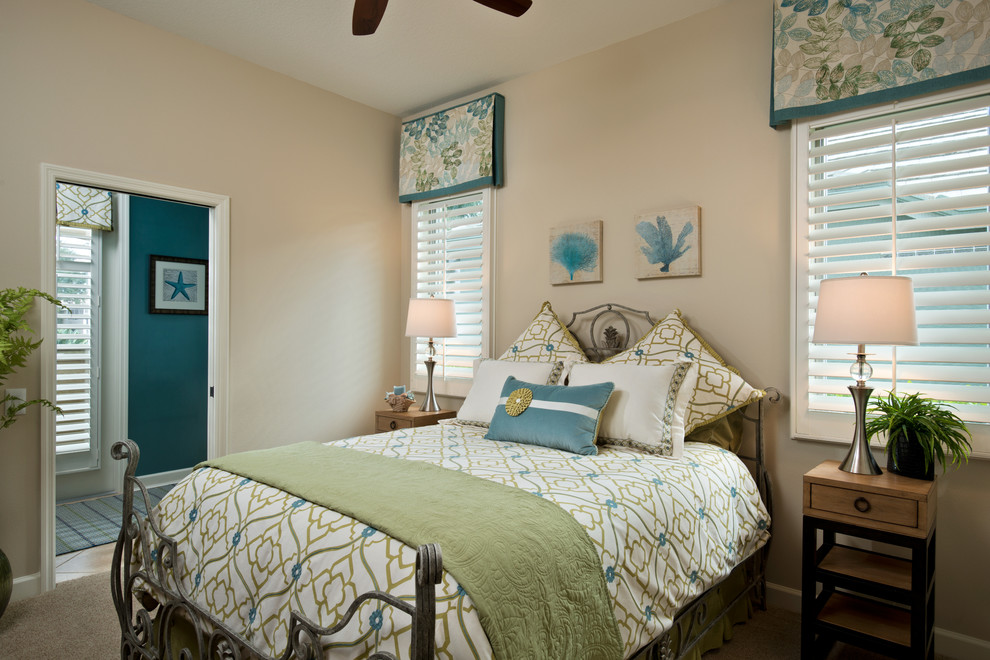 Photo of a mid-sized tropical guest bedroom in Other with white walls, carpet and beige floor.