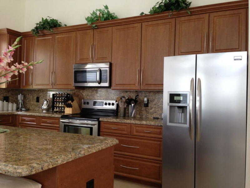 Inspiration for a mid-sized l-shaped eat-in kitchen remodel in Miami with beaded inset cabinets, medium tone wood cabinets, stainless steel countertops, multicolored backsplash, matchstick tile backsplash, stainless steel appliances and an island
