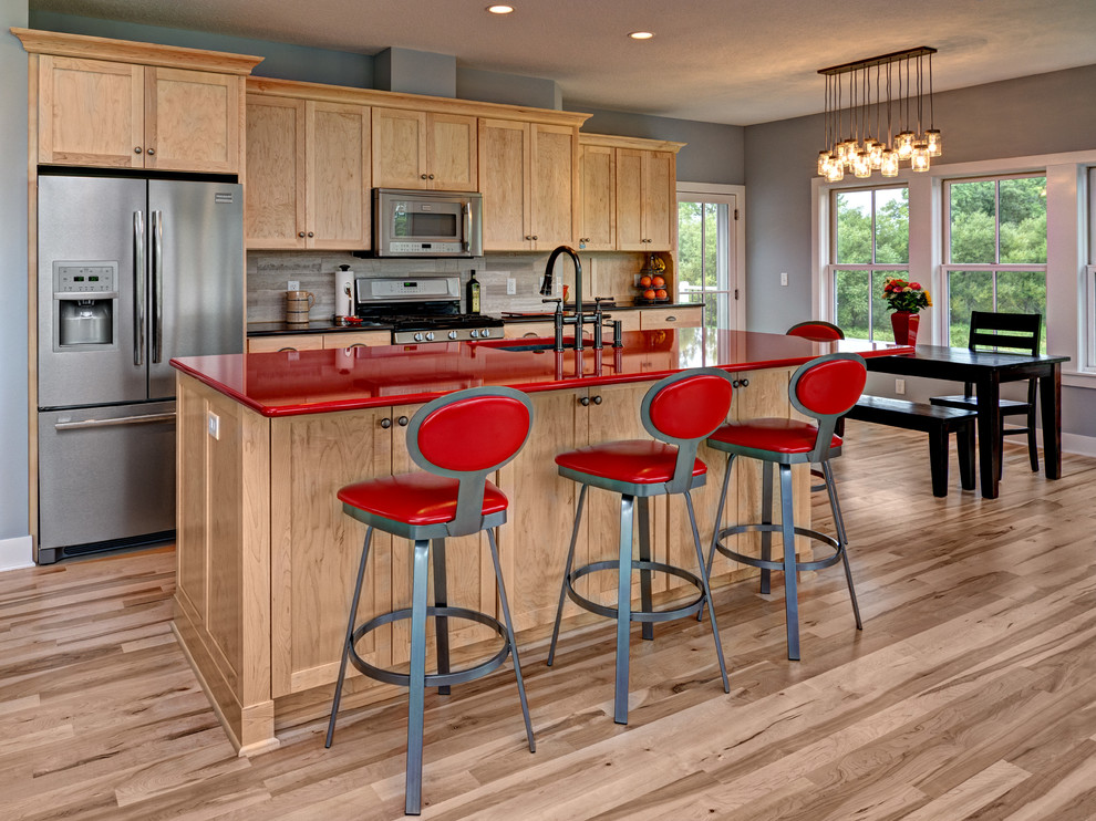 Transitional galley eat-in kitchen in Minneapolis with an undermount sink, shaker cabinets, light wood cabinets, grey splashback, stainless steel appliances and red benchtop.