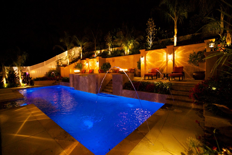 Photo of a large modern backyard rectangular lap pool in San Diego with concrete slab.
