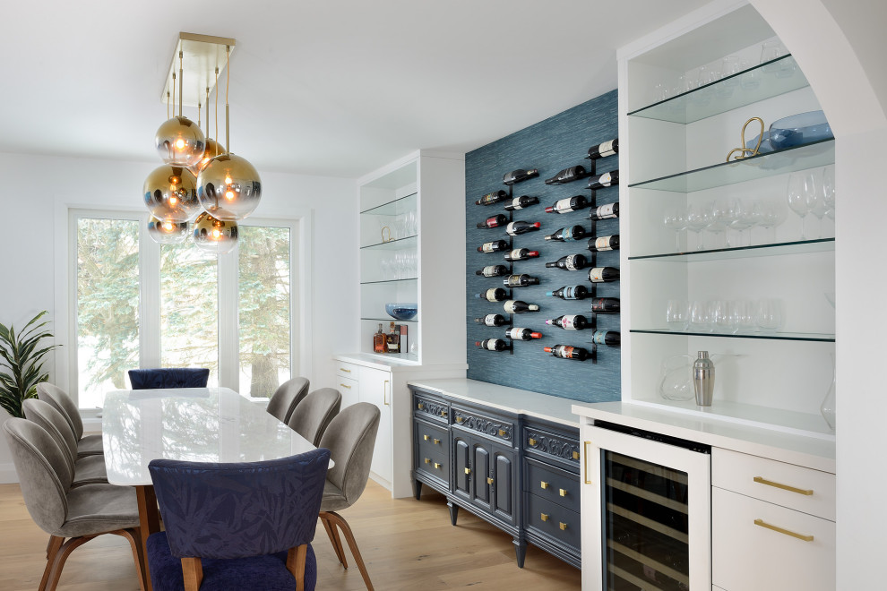 Inspiration for a mid-sized midcentury galley home bar in Toronto with shaker cabinets, white cabinets, quartz benchtops, blue splashback, light hardwood floors, brown floor and white benchtop.