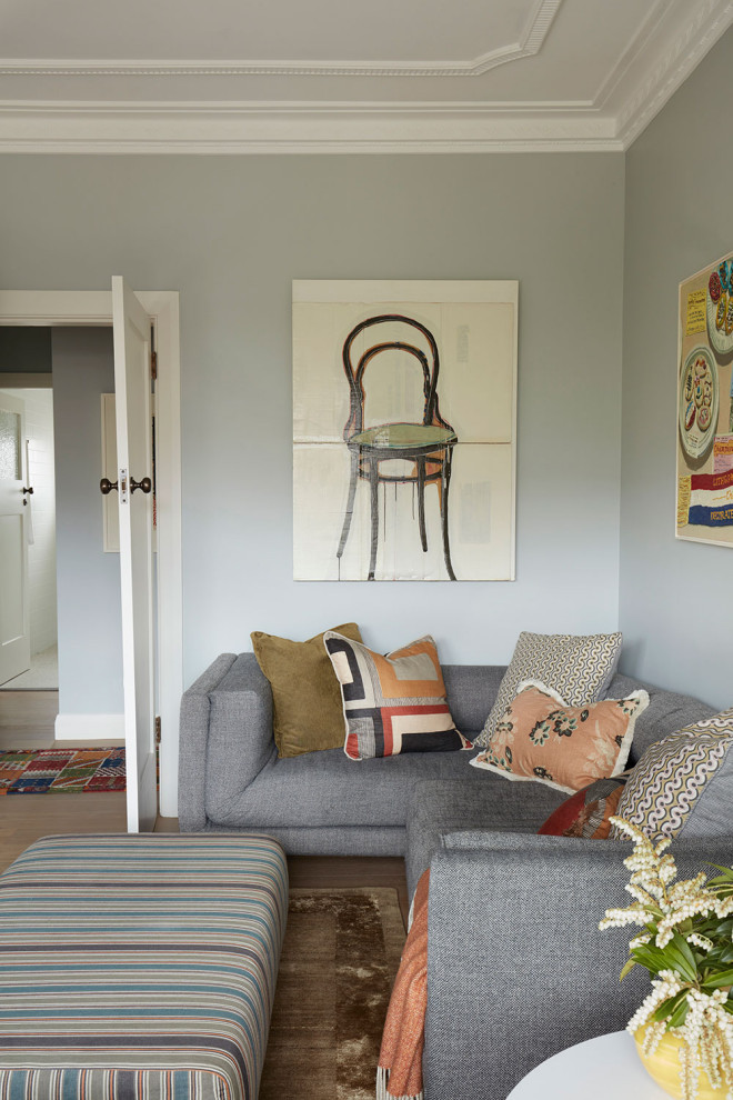 Inspiration for a large eclectic enclosed family room in Sydney with blue walls and a freestanding tv.