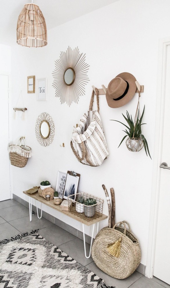 Design ideas for a beach style foyer in Montpellier with white walls, concrete floors, a white front door and grey floor.