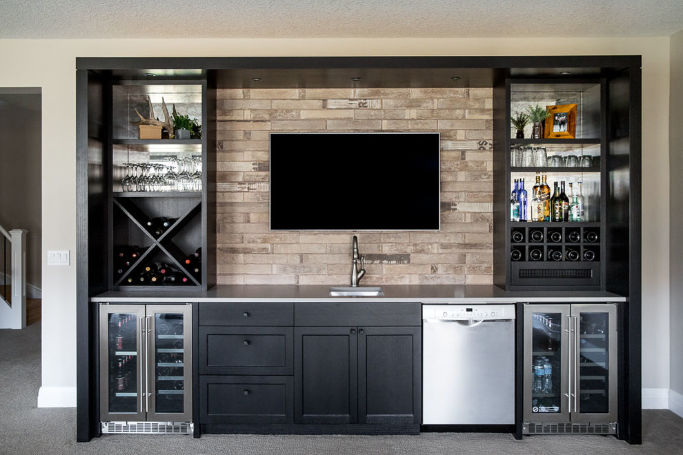 This is an example of a small traditional galley wet bar in Calgary with an undermount sink, shaker cabinets, black cabinets, quartz benchtops, grey splashback, porcelain splashback and grey benchtop.