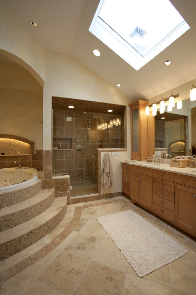 Inspiration for a mid-sized contemporary master bathroom in Chicago with raised-panel cabinets, light wood cabinets, a hot tub, a double shower, a one-piece toilet, beige tile, stone tile, multi-coloured walls, travertine floors, an undermount sink and marble benchtops.
