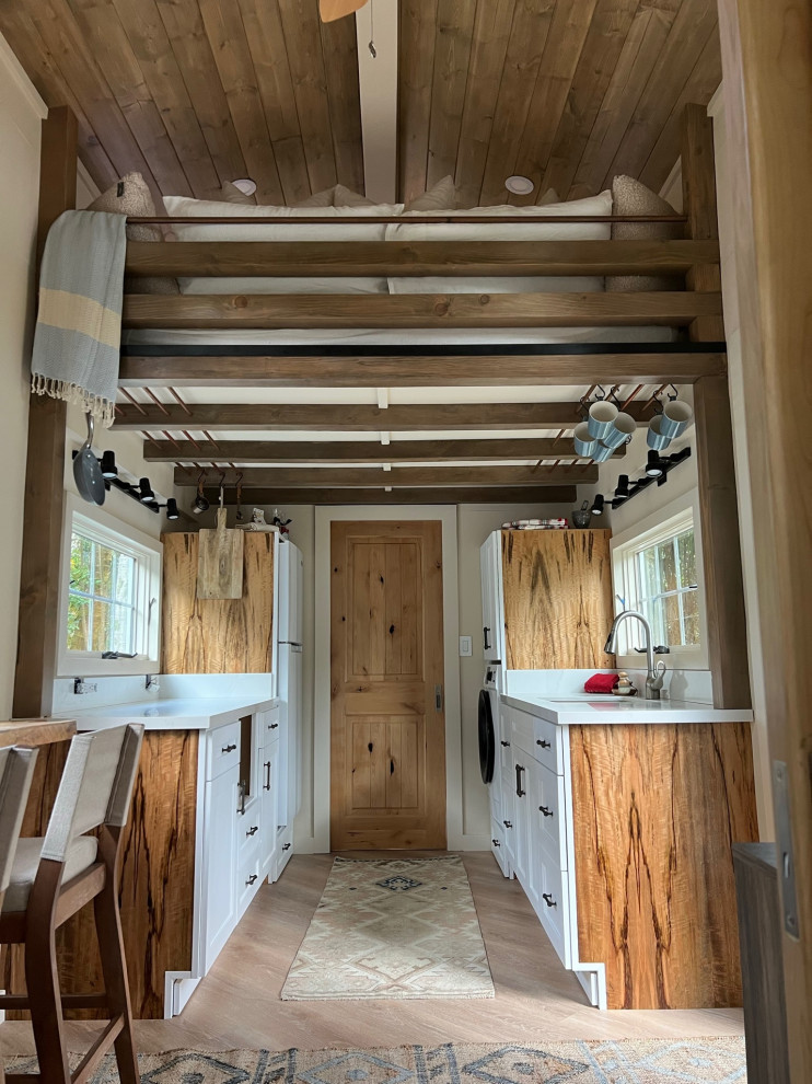 Photo of a small nautical galley kitchen/diner in Hawaii with a submerged sink, shaker cabinets, white cabinets, engineered stone countertops, engineered quartz splashback, stainless steel appliances, vinyl flooring, beige floors, white worktops and exposed beams.