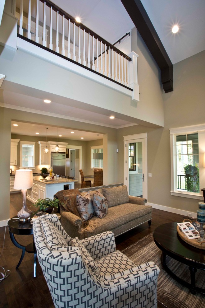 Photo of a traditional open concept living room in Grand Rapids with beige walls, dark hardwood floors and brown floor.