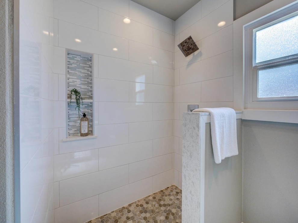 Photo of a mid-sized country 3/4 bathroom in Other with beaded inset cabinets, green cabinets, an open shower, a two-piece toilet, white tile, ceramic tile, grey walls, ceramic floors, an integrated sink, solid surface benchtops, white floor and an open shower.