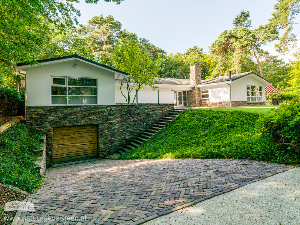 Trendy brown stone exterior home photo in Amsterdam