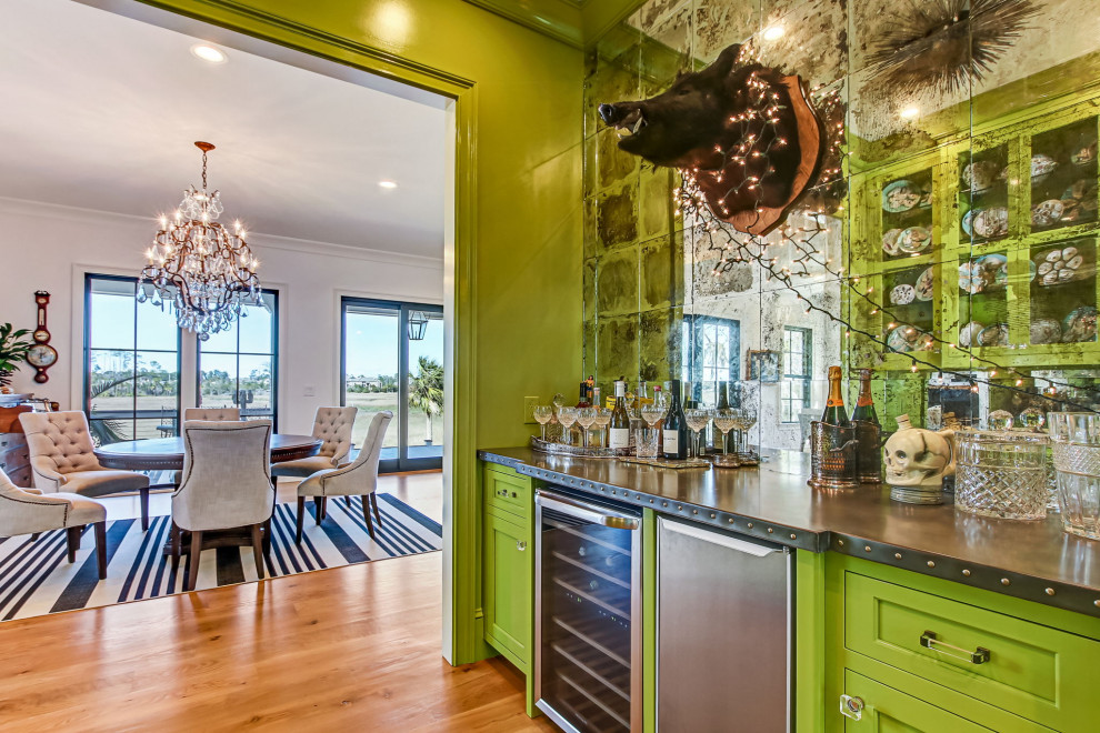 Photo of a mid-sized eclectic single-wall wet bar in Other with shaker cabinets, green cabinets, mirror splashback, medium hardwood floors, brown floor and brown benchtop.