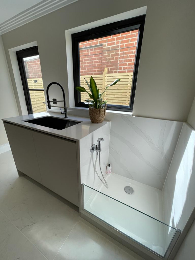 Photo of a contemporary laundry room in Other with an integrated sink, flat-panel cabinets, grey cabinets, quartzite benchtops, white splashback, stone slab splashback, beige walls, porcelain floors, a side-by-side washer and dryer, white floor and white benchtop.