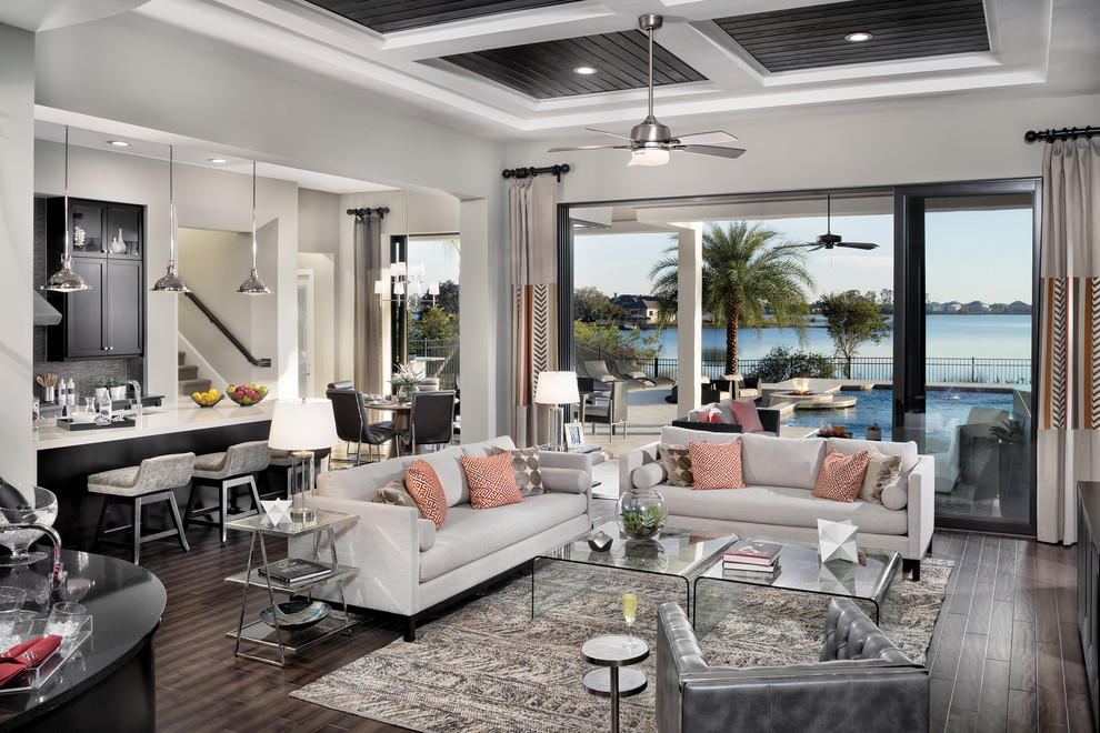 Inspiration for an expansive transitional open concept family room in Tampa with white walls and dark hardwood floors.
